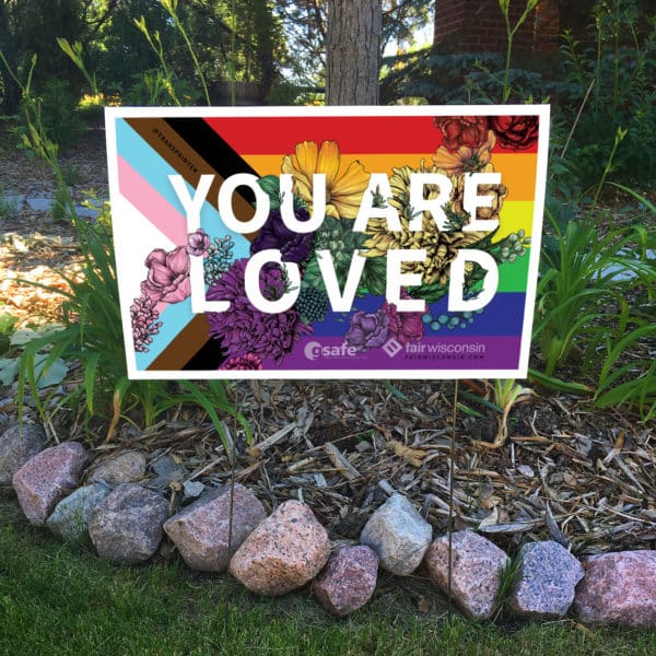 a yard sign that says you are loved, proceeds benefit Fair Wisconsin