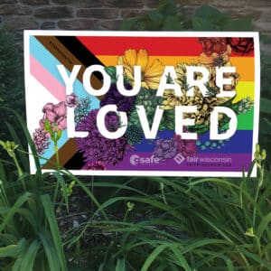 You Are Loved Yard Sign surrounded by grass and flowers