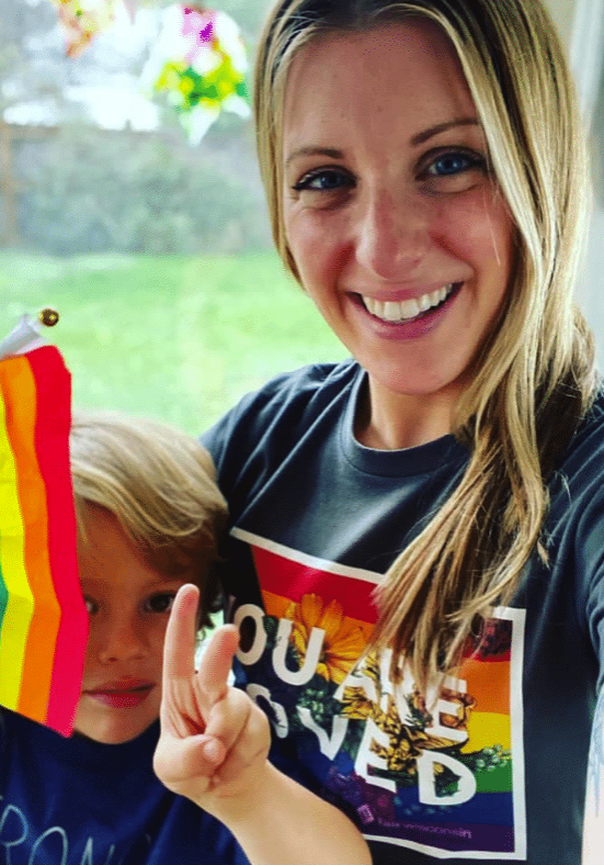 Mom and Kid Wearing a Fair Wisconsin shirt that say You Are Loved with the Pride Flag